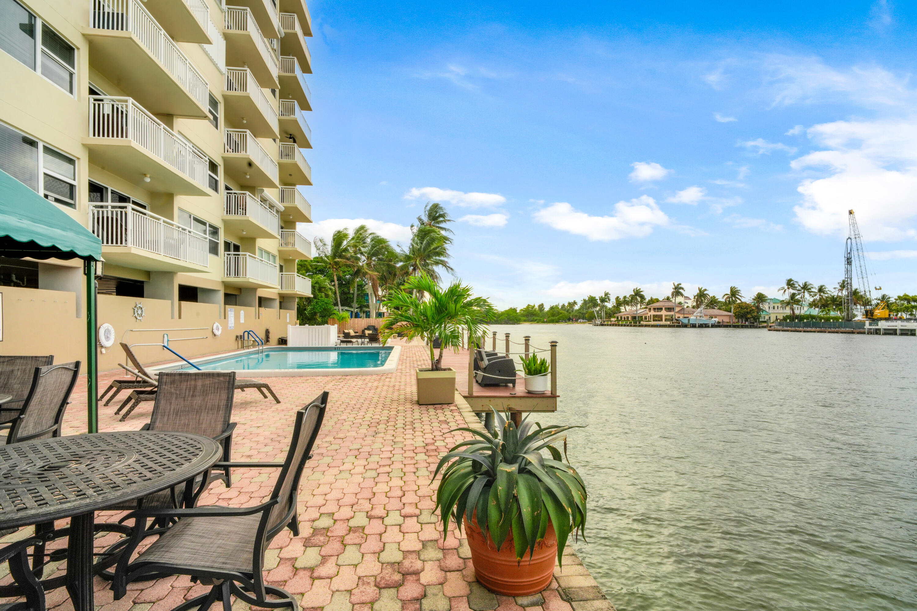 2611 North Riverside Drive, Unit 1004 Pompano Beach, FL 33062 - Photo 25 of 32 a view of a lake with couches chairs and city view