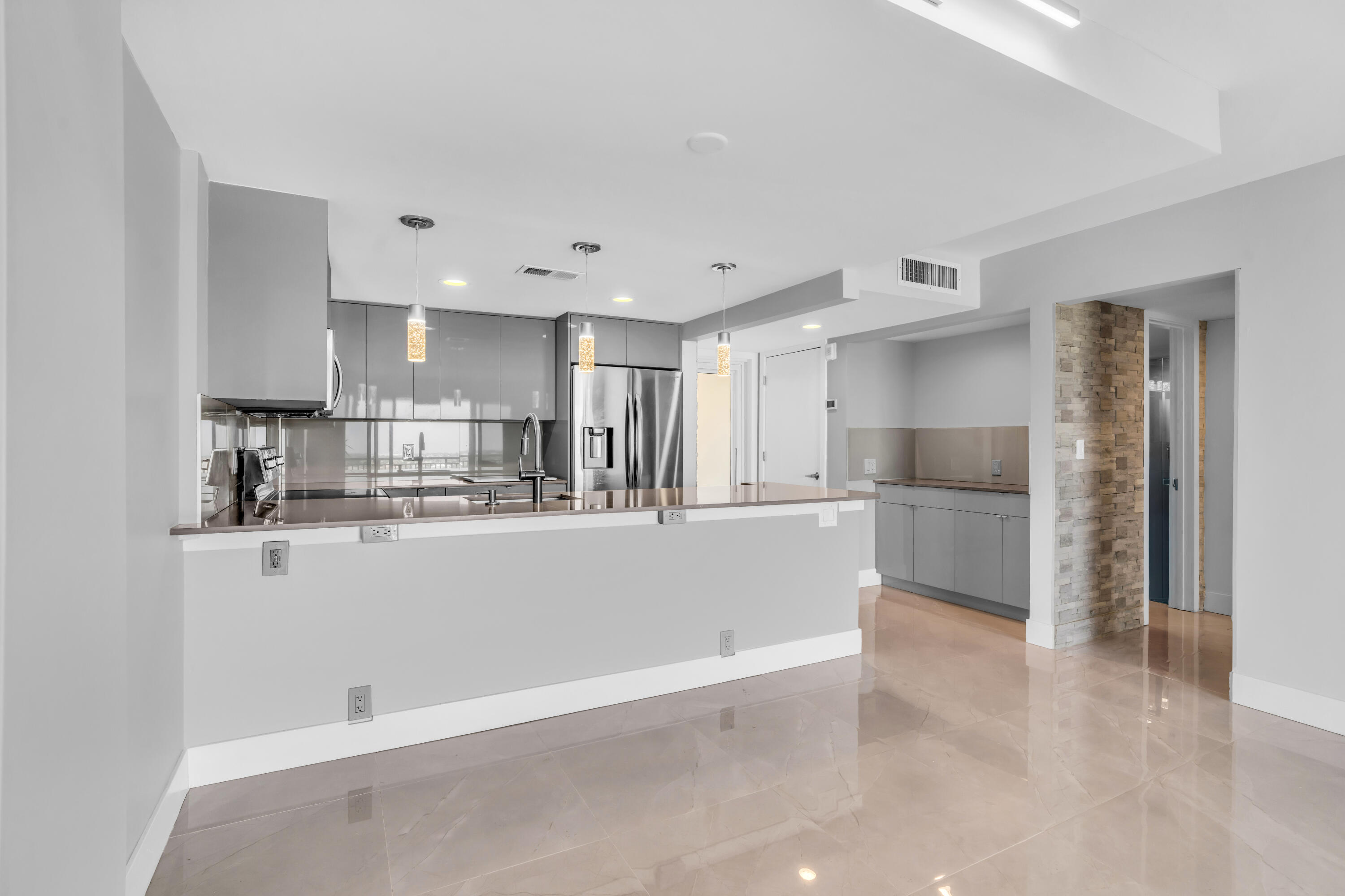 2611 North Riverside Drive, Unit 1004 Pompano Beach, FL 33062 - Photo 3 of 32 a view of kitchen with refrigerator sink and cabinets