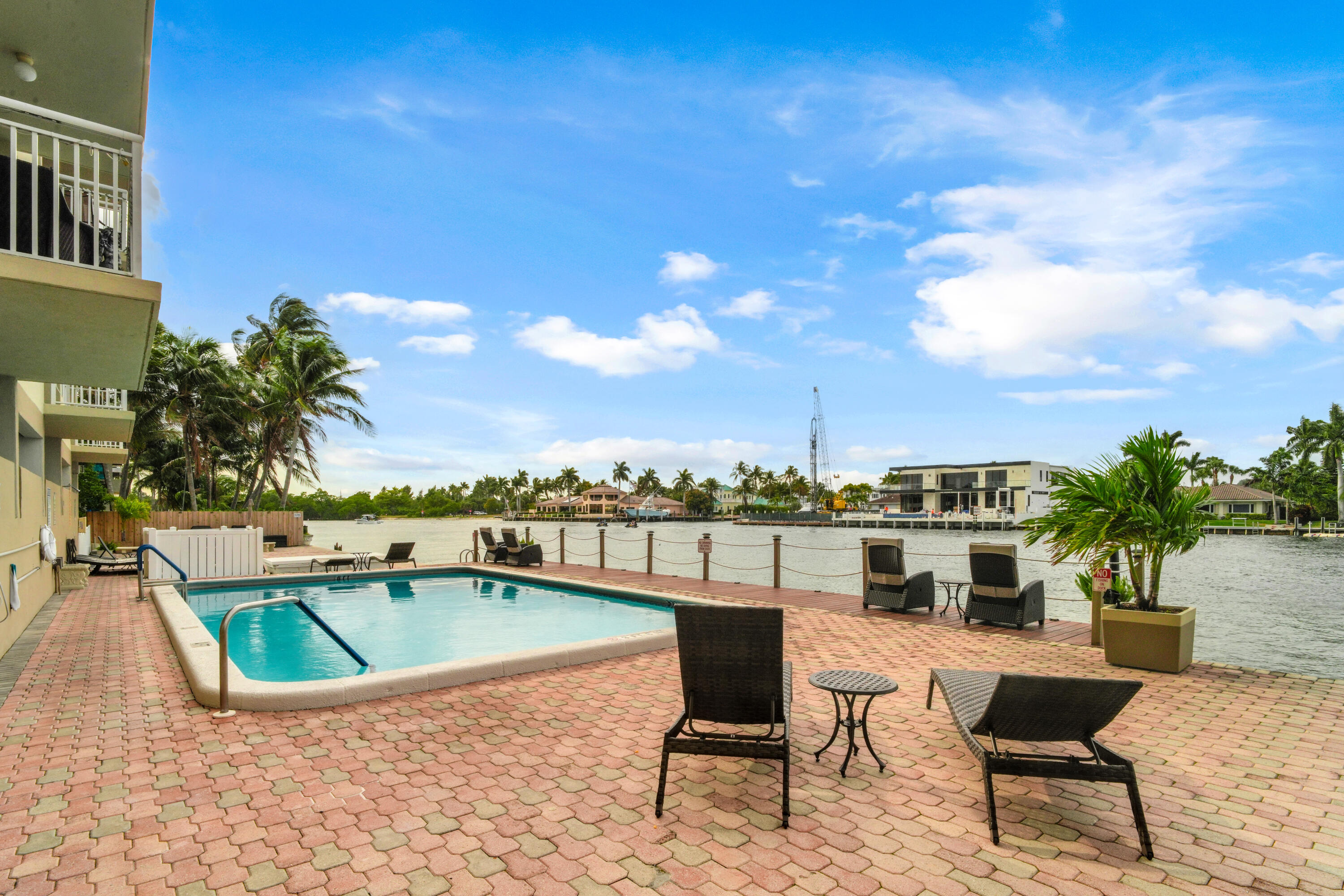 2611 North Riverside Drive, Unit 1004 Pompano Beach, FL 33062 - Photo 31 of 32 a view of a swimming pool with a lounge chair