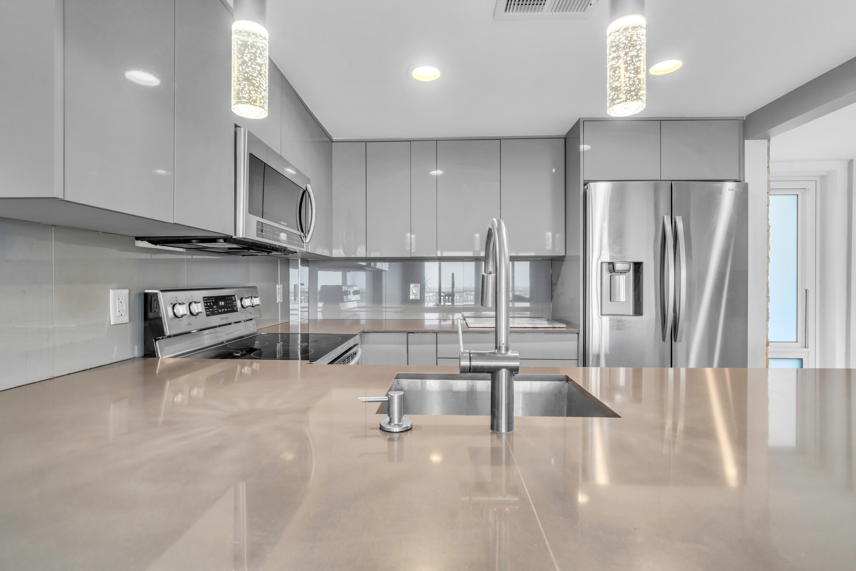 2611 North Riverside Drive, Unit 1004 Pompano Beach, FL 33062 - Photo 4 of 32 a kitchen with stainless steel appliances granite countertop a refrigerator and a sink