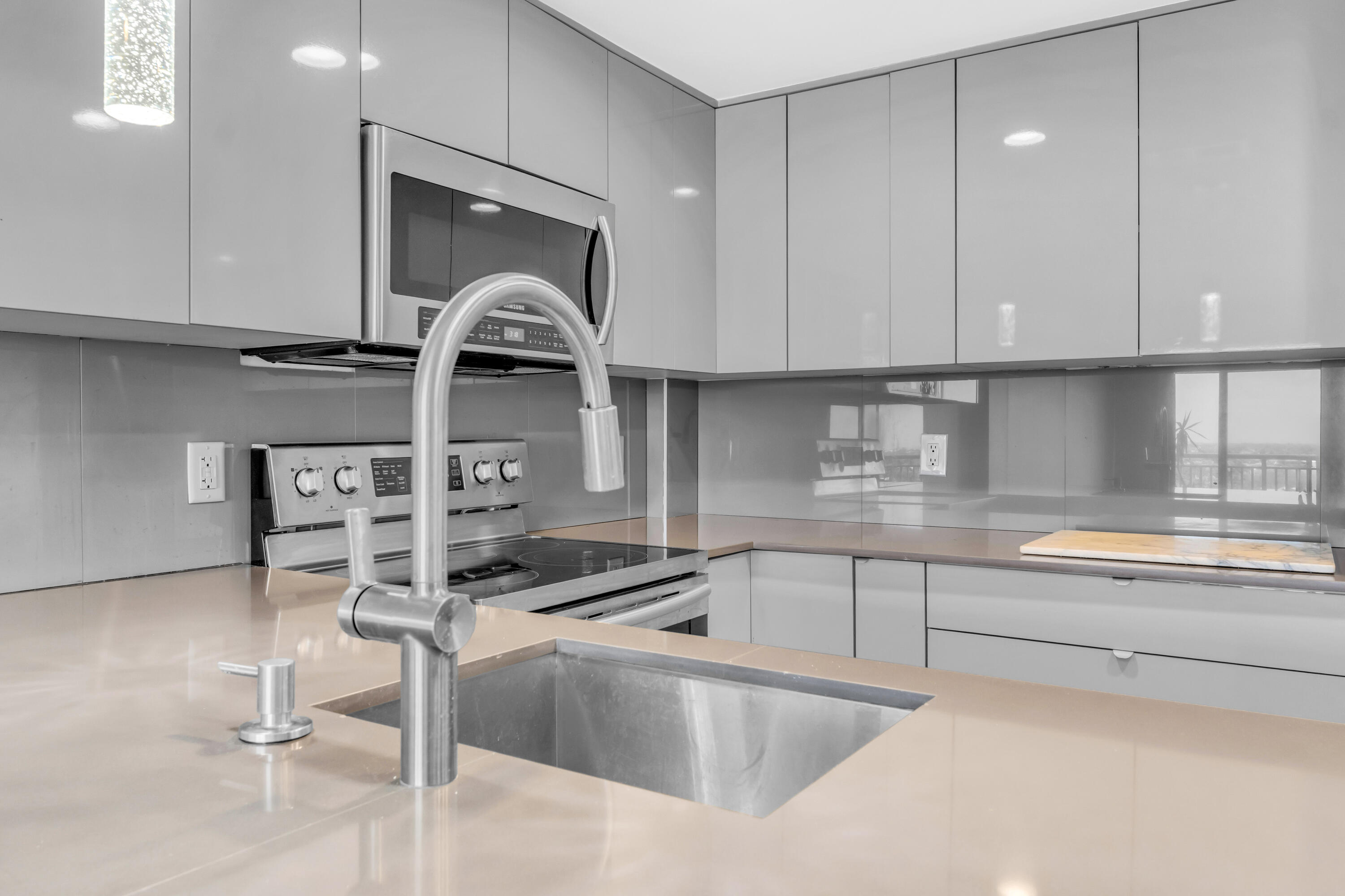 2611 North Riverside Drive, Unit 1004 Pompano Beach, FL 33062 - Photo 5 of 32 a kitchen with a sink and cabinets
