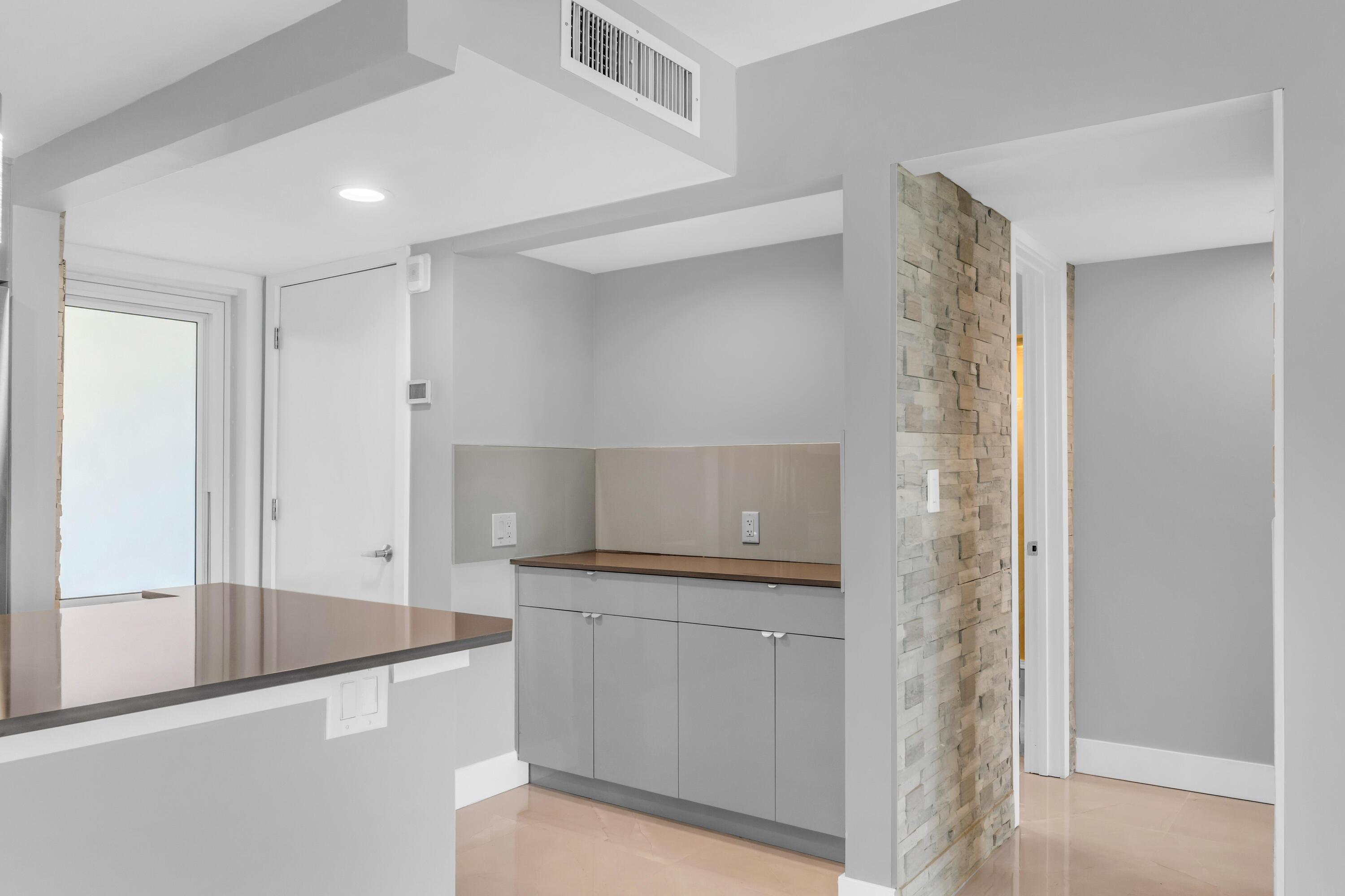 2611 North Riverside Drive, Unit 1004 Pompano Beach, FL 33062 - Photo 7 of 32 a kitchen with a sink and cabinets