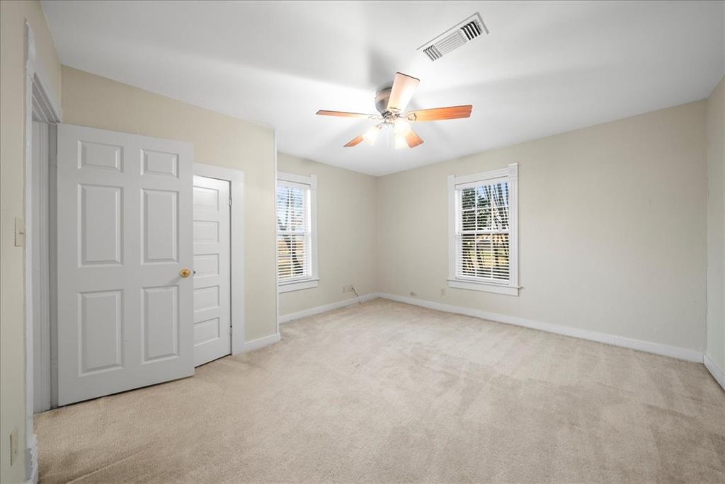 101 North 7th Street Krum, TX 76249 - Photo 10 of 26 Unfurnished bedroom featuring light carpet and a ceiling fan