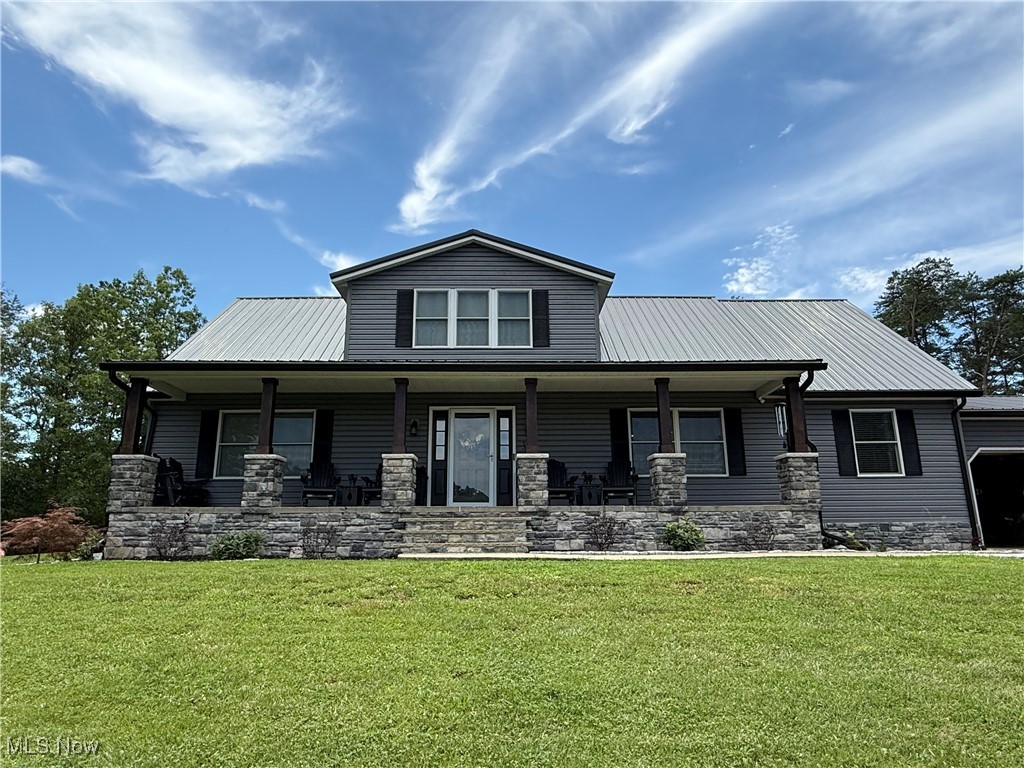 399 Wilder Road Vinton, OH 45686 - Photo 2 of 36 View of front of property featuring a porch, a front lawn, a metal roof, and stone siding