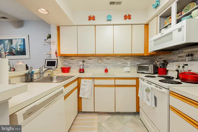 a kitchen with a refrigerator and a sink