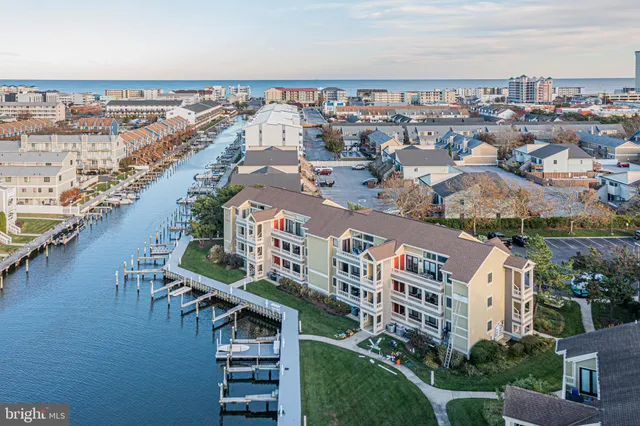 an aerial view of a house with outdoor space and lake view