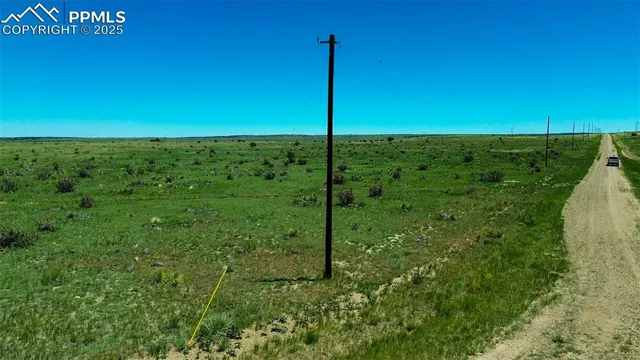 a view of a field with an ocean view