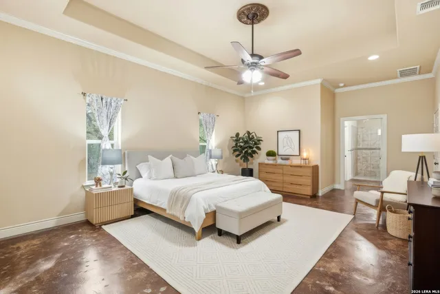 a spacious bedroom with a large bed and a chandelier