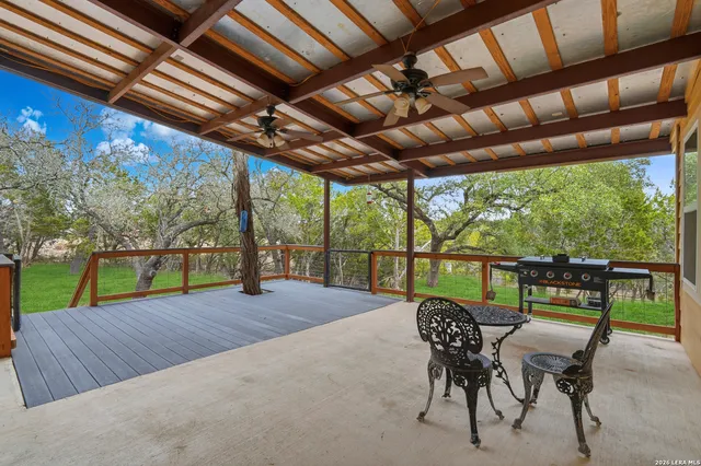 a view of a patio with a table chairs and a backyard