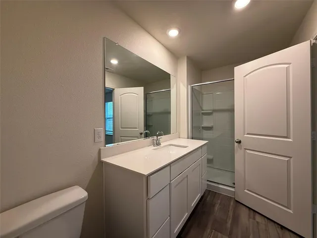a bathroom with a sink a toilet and a mirror