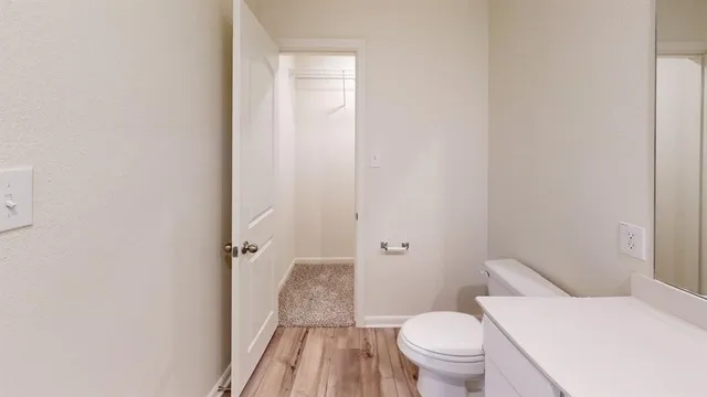 a white toilet sitting next to a bathroom sink and a shower