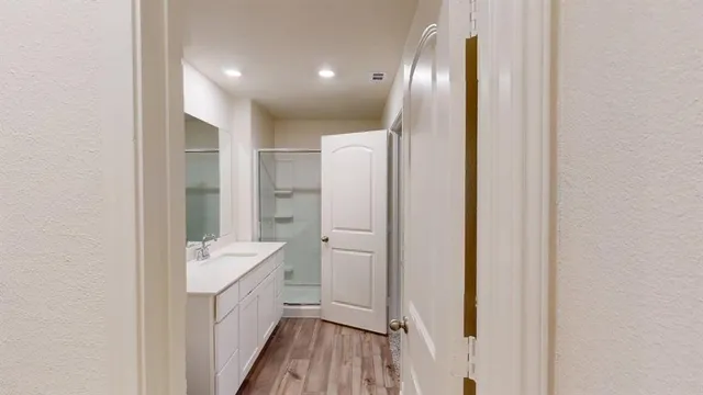 a bathroom with a sink a mirror and a shower