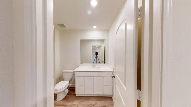 a bathroom with a sink a toilet and mirror