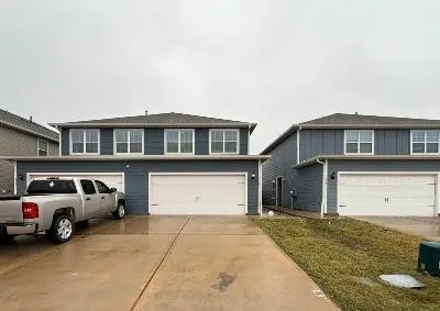 a front view of a house with a parking space