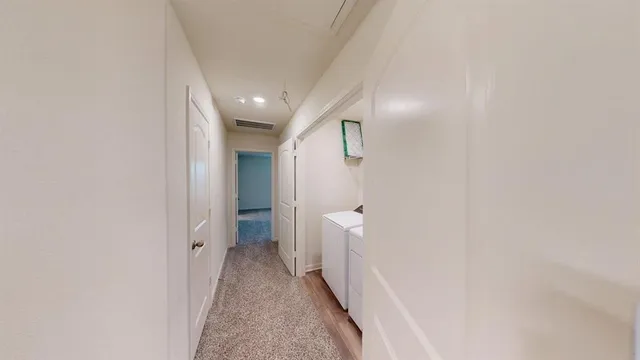 a view of a hallway with white walls