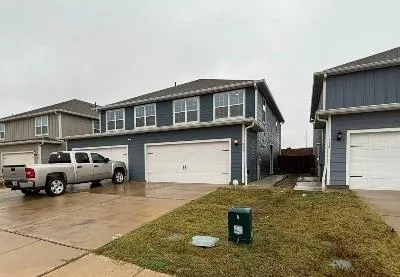 a front view of a house with parking