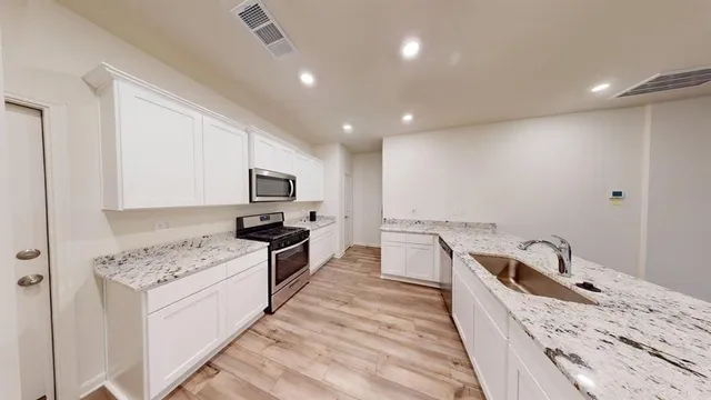 a kitchen with a sink stove and refrigerator