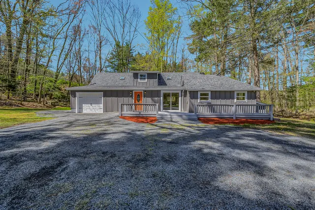 a view of house with outdoor space and swimming pool