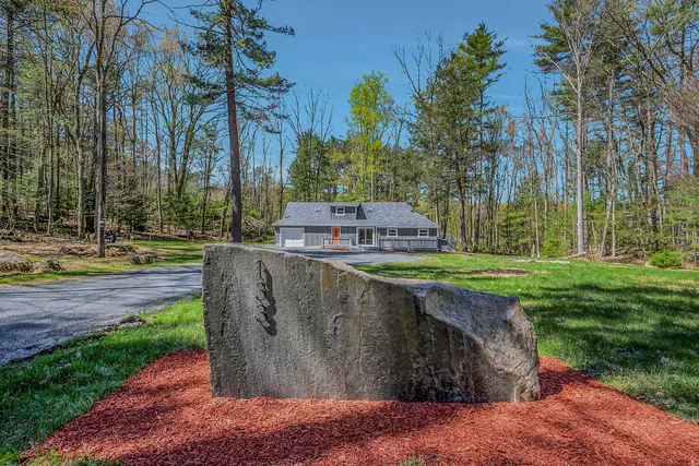 a kitchen with a refrigerator and wooden floor