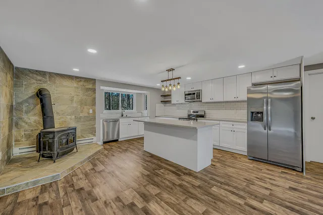 a kitchen with counter top space a sink and appliances