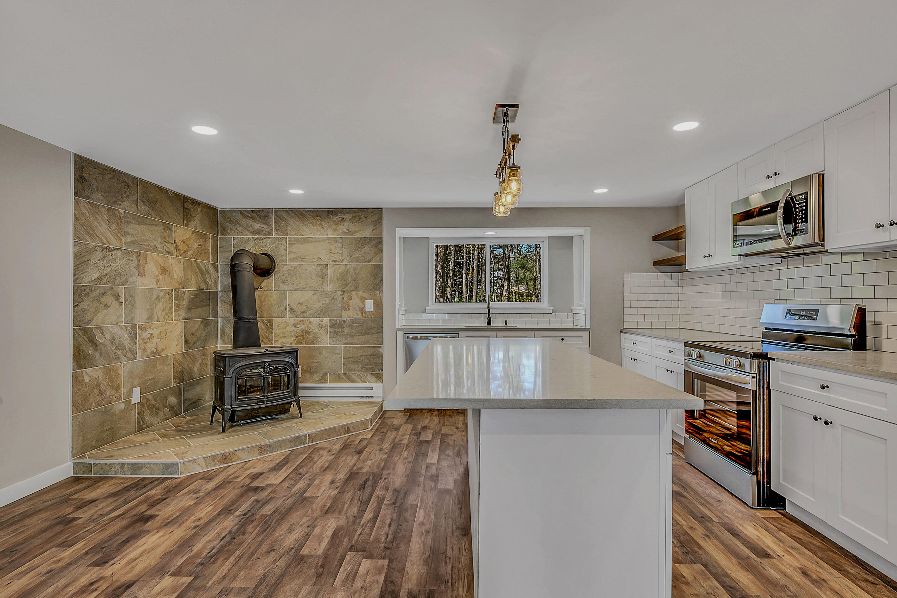 133 Neil Thompson Road Lackawaxen, PA 18425 - Photo 24 of 65 a kitchen with kitchen island a counter top space a sink stainless steel appliances and cabinets