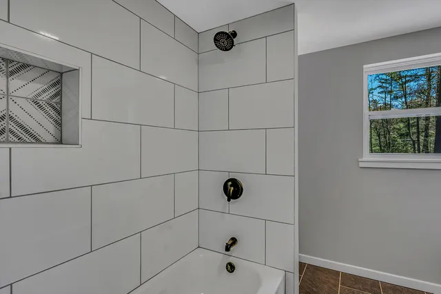 a view of room with window and wooden floor