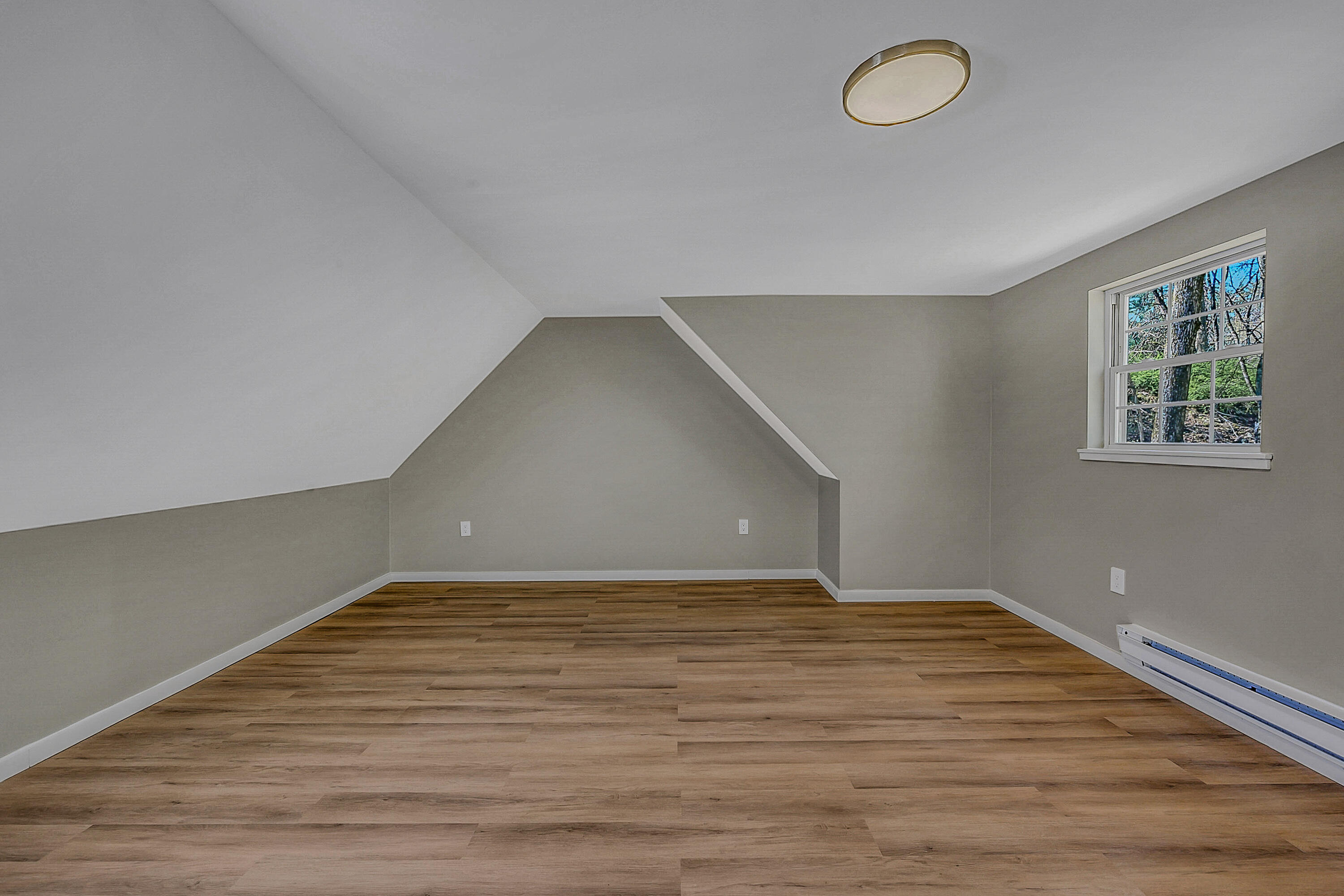 133 Neil Thompson Road Lackawaxen, PA 18425 - Photo 32 of 65 a view of an empty room with wooden floor and window