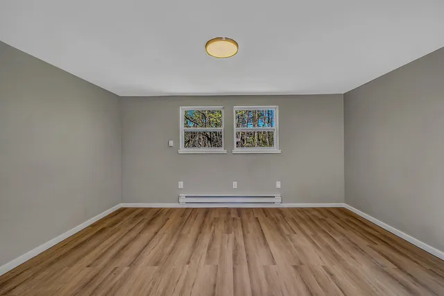 a view of room with wooden floor and window