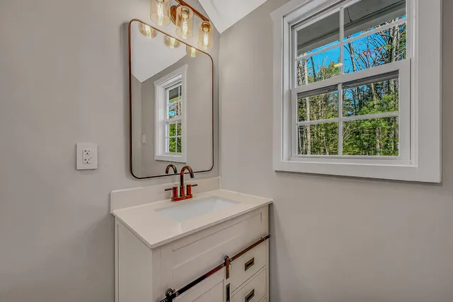 a view of a room with wooden floor and a window