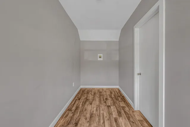 a aerial view of a house with a yard and large trees