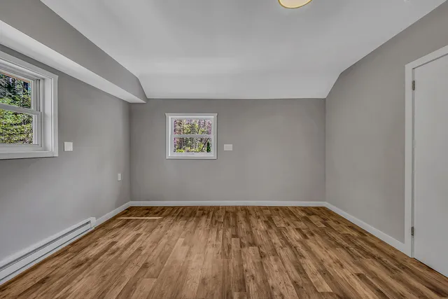 a backyard of a house with a yard and outdoor seating