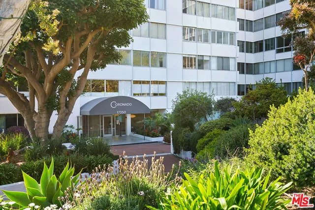 a front view of a residential apartment building with a yard