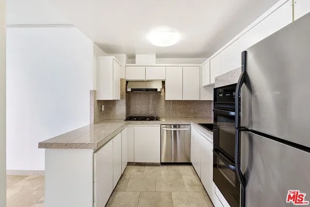 a kitchen with a sink stove and refrigerator