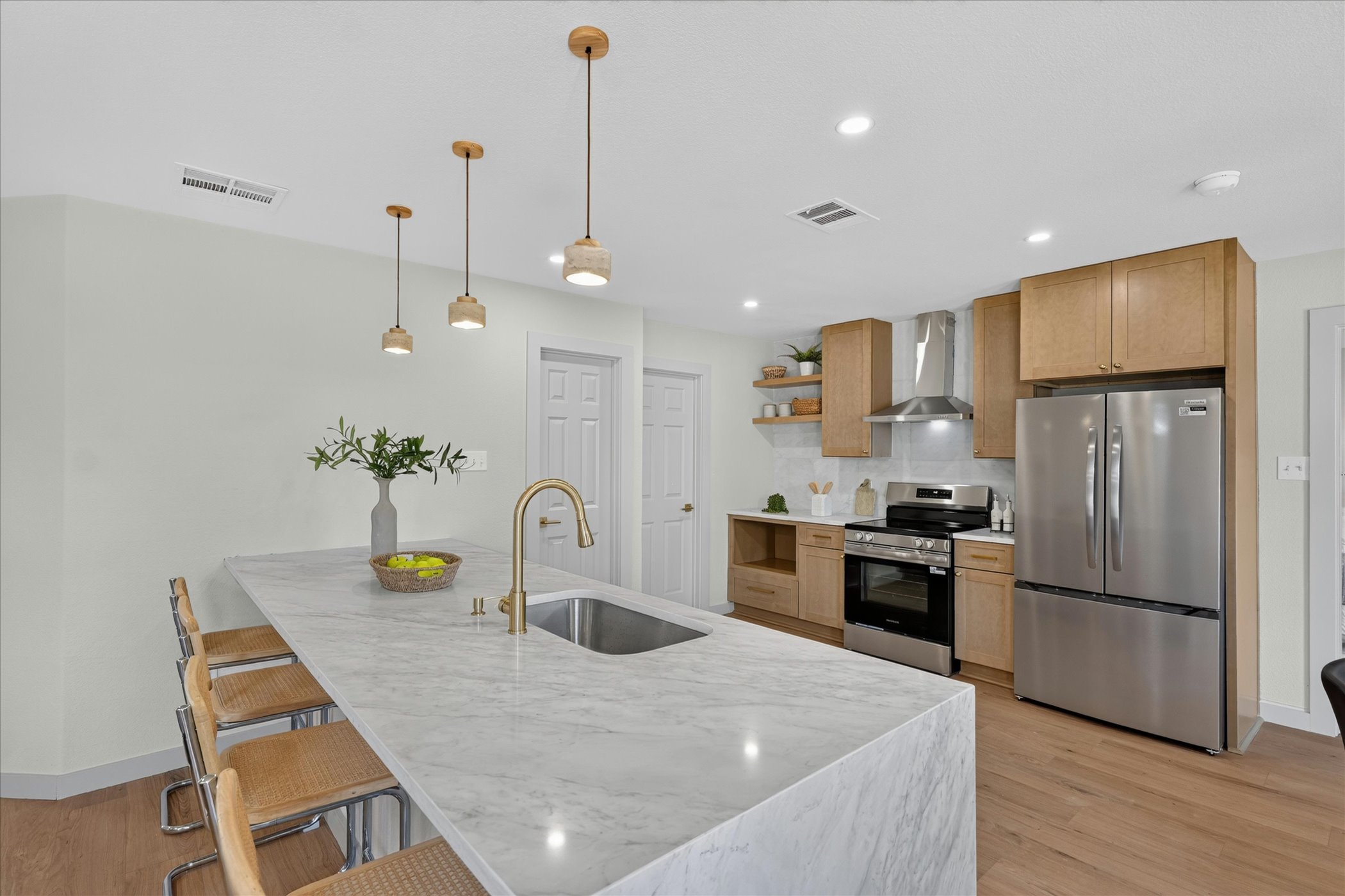 258 Pine View Loop Bastrop, TX 78602 - Photo 21 of 40 A gourmet kitchen awaits, boasting a spacious marble island and stainless steel appliances.