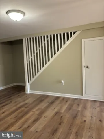 an empty room with wooden floor