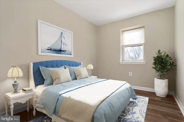 a bedroom with bed and wooden floor