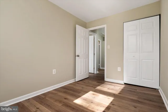 an empty room with wooden floor
