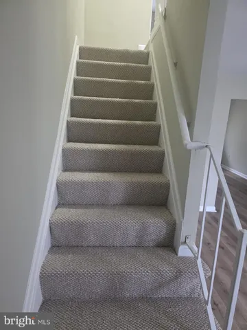 a view of staircase with white walls