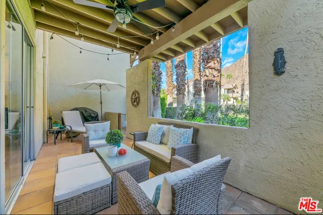 a outdoor living space with furniture and a black umbrella
