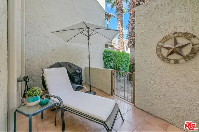 a view of a room with a table and chairs