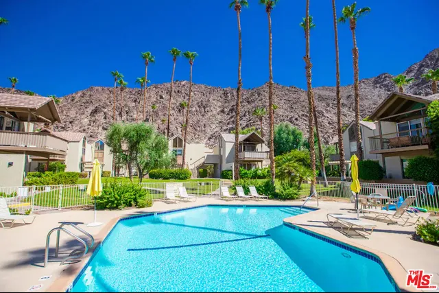 a view of a building with cars parked in front of it