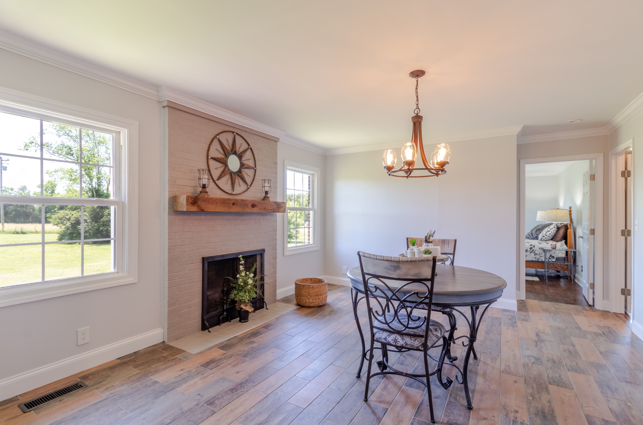 1441 Pleasant View Road Woodbury, TN 37190 - Photo 27 of 32 a dining room with furniture a fireplace and wooden floor