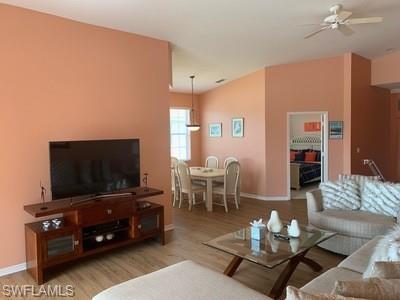 2021 Crestview Way, Unit 113 Naples, FL 34119 - Photo 11 of 24 a living room with furniture and a flat screen tv