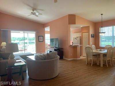 2021 Crestview Way, Unit 113 Naples, FL 34119 - Photo 12 of 24 a living room with furniture and a large window
