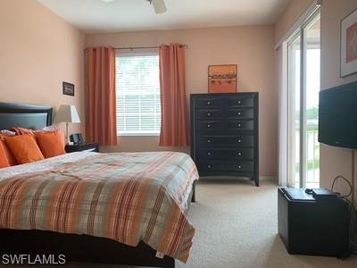 2021 Crestview Way, Unit 113 Naples, FL 34119 - Photo 14 of 24 a bedroom with a bed and a television