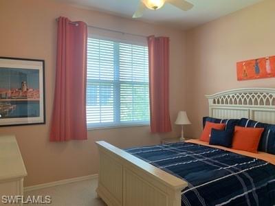 2021 Crestview Way, Unit 113 Naples, FL 34119 - Photo 19 of 24 a bed sitting in a bedroom next to a window