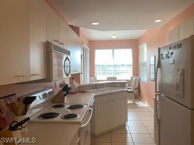 2021 Crestview Way, Unit 113 Naples, FL 34119 - Photo 4 of 24 a kitchen with sink refrigerator and window