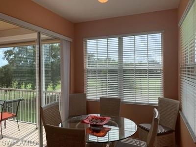 2021 Crestview Way, Unit 113 Naples, FL 34119 - Photo 7 of 24 a living room with furniture and a window