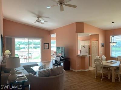2021 Crestview Way, Unit 113 Naples, FL 34119 - Photo 9 of 24 a living room with furniture and a large window