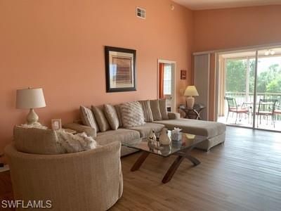 2021 Crestview Way, Unit 113 Naples, FL 34119 - Photo 10 of 24 a living room with furniture and a large window